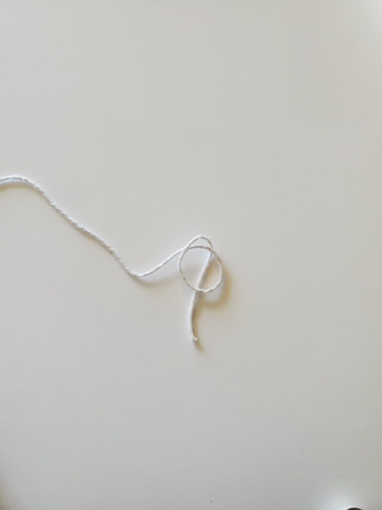 Tucked yarn tail behind loop