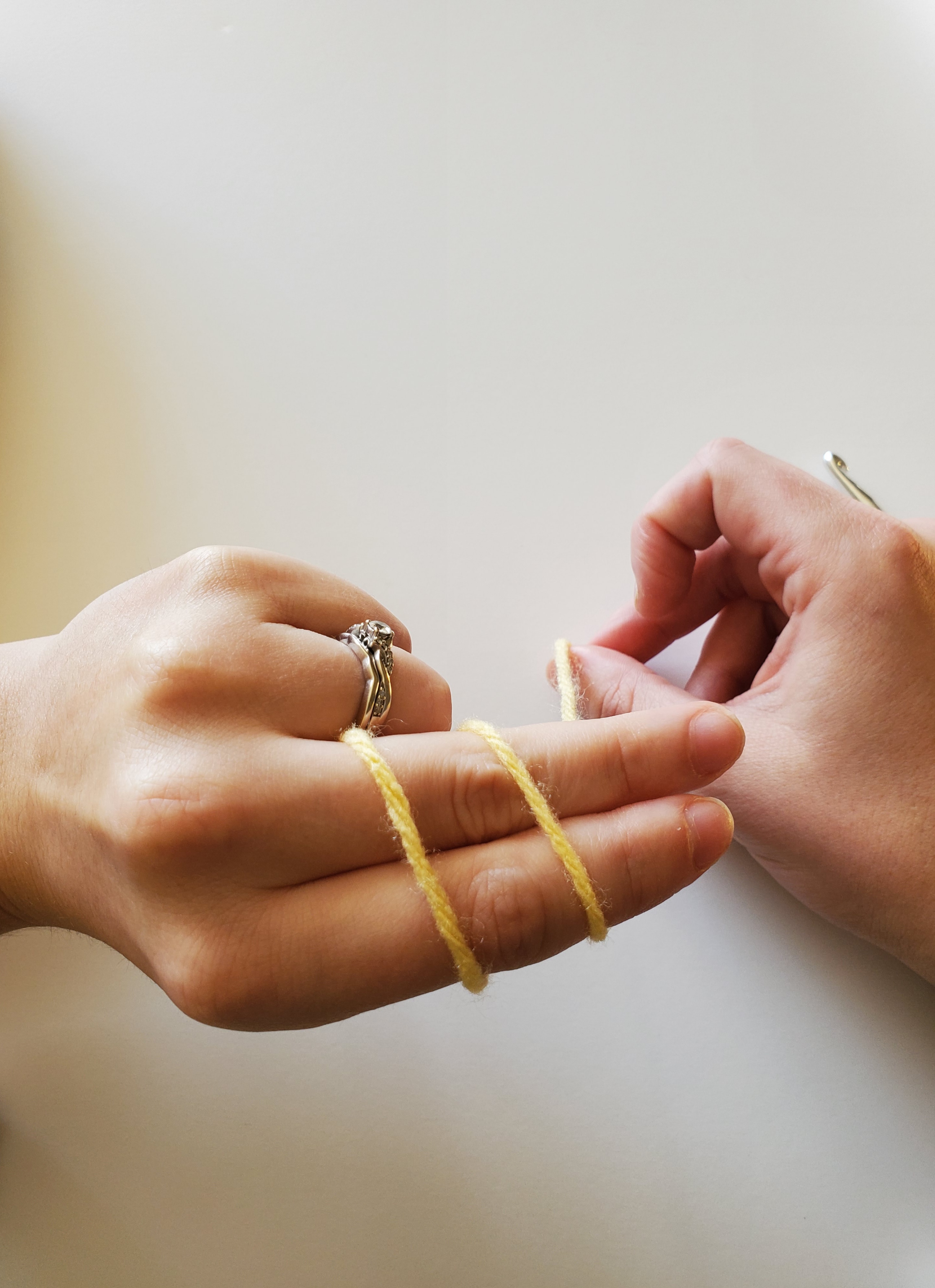 Top view of turned hand while holding yarn in place