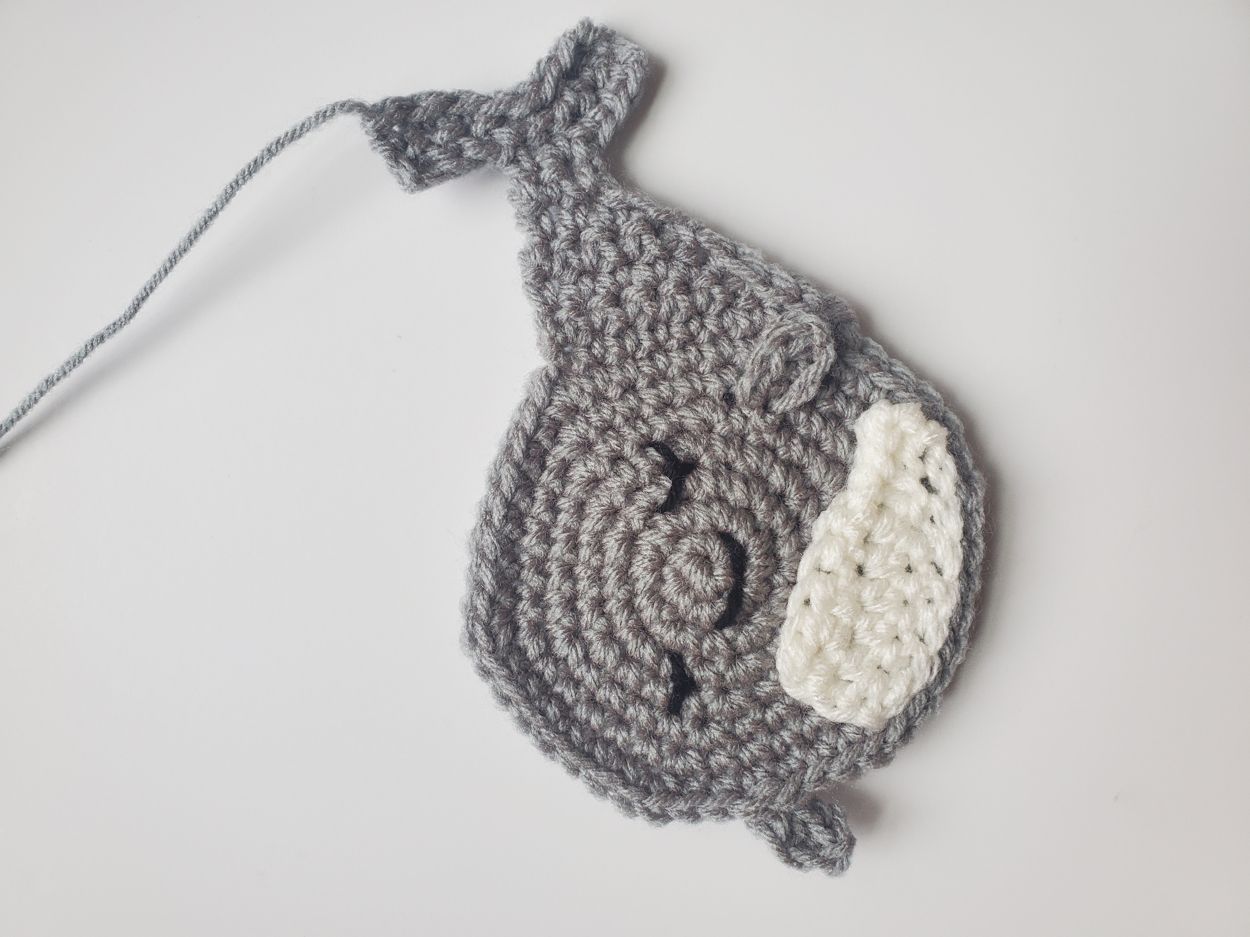 Front panel of crochet whale with finished facial features
