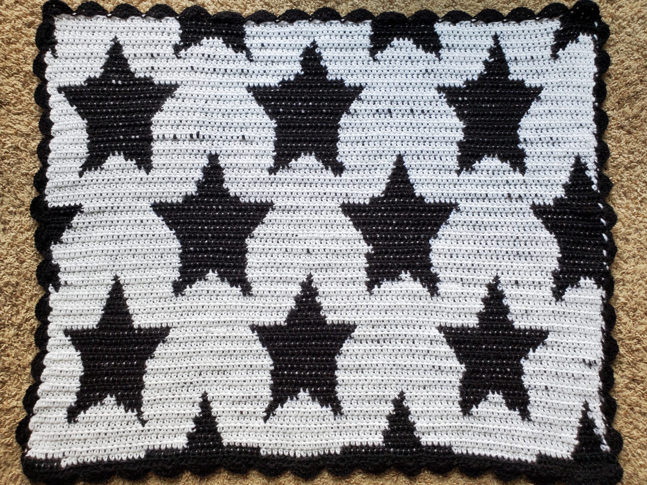 Completed black and white crochet baby blanket